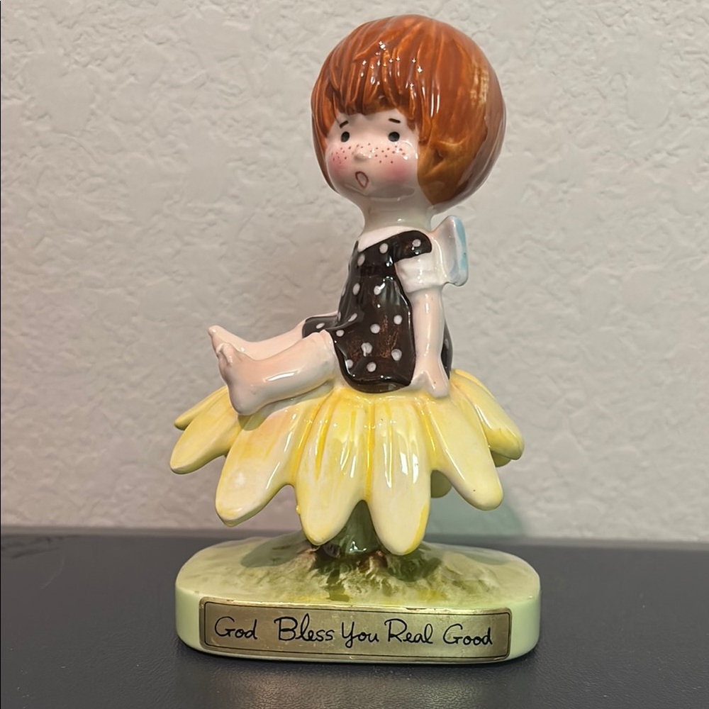 ✨ Ceramic Figurine on Yellow Flower